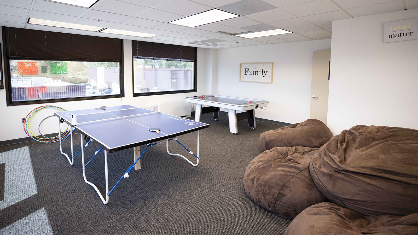 Recreation room with a ping pong table and bean bags..