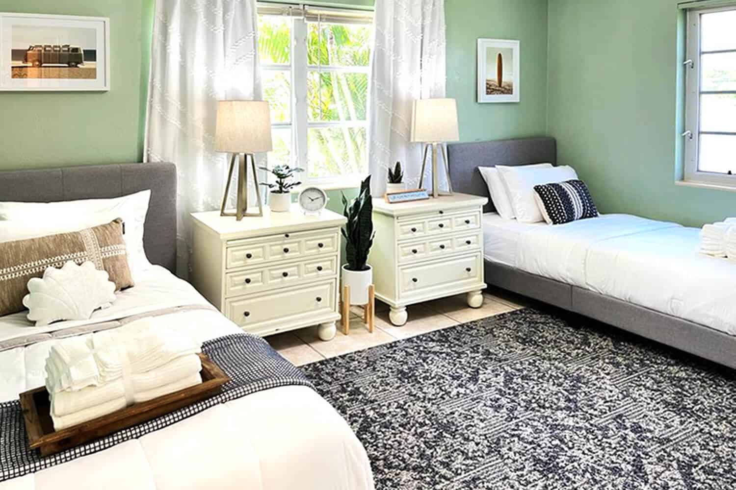 Bright shared bedroom with two twin beds and nightstands.