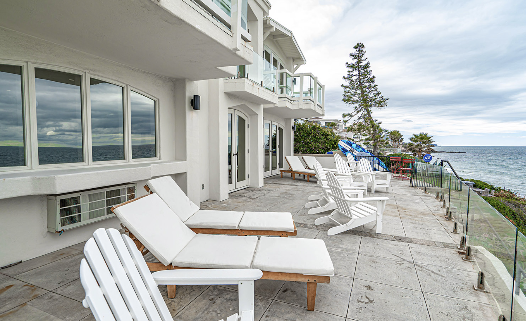 Patio seating with lounge chairs overlooking ocean