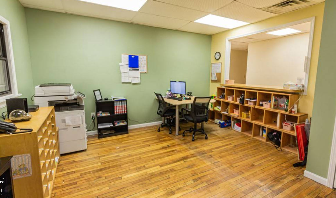 Admissions office with desks, storage cubbies, and computers