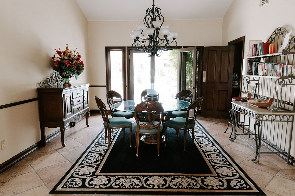 Dining room with glass table and decorative rug
