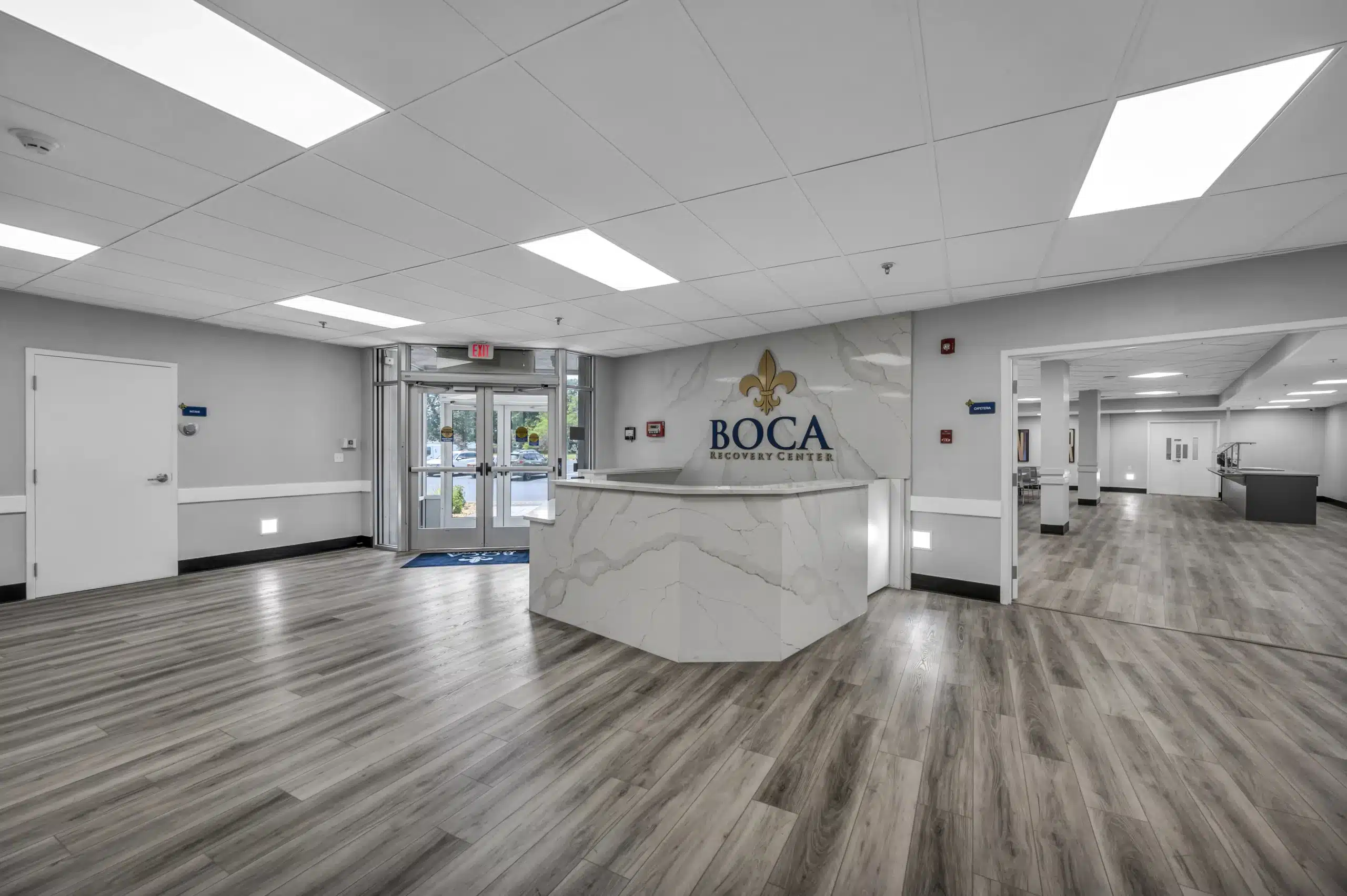 Welcoming front lobby with marble reception desk and modern flooring at Boca Recovery Center Massachusetts