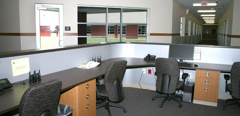 Reception desk with computer workstations and hallway view