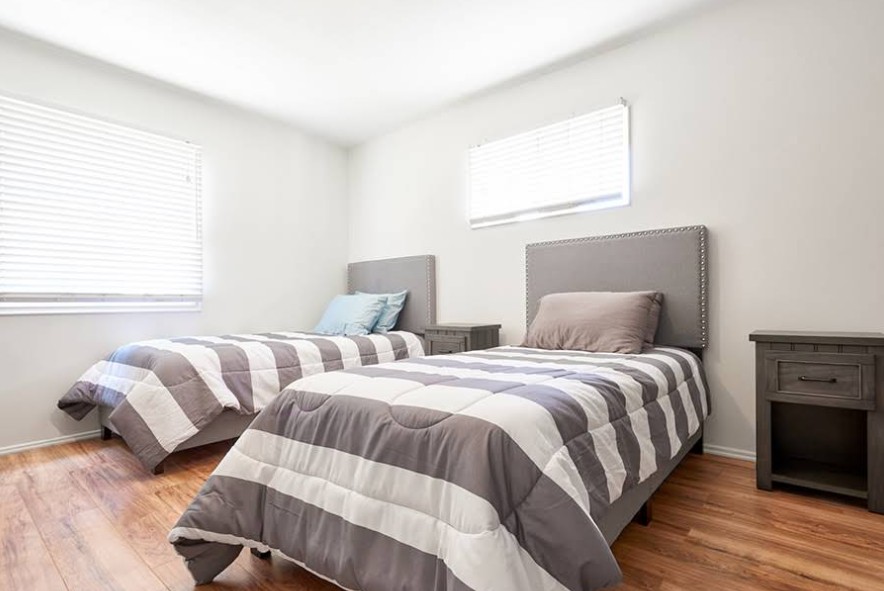 Shared bedroom with two beds and bedside tables