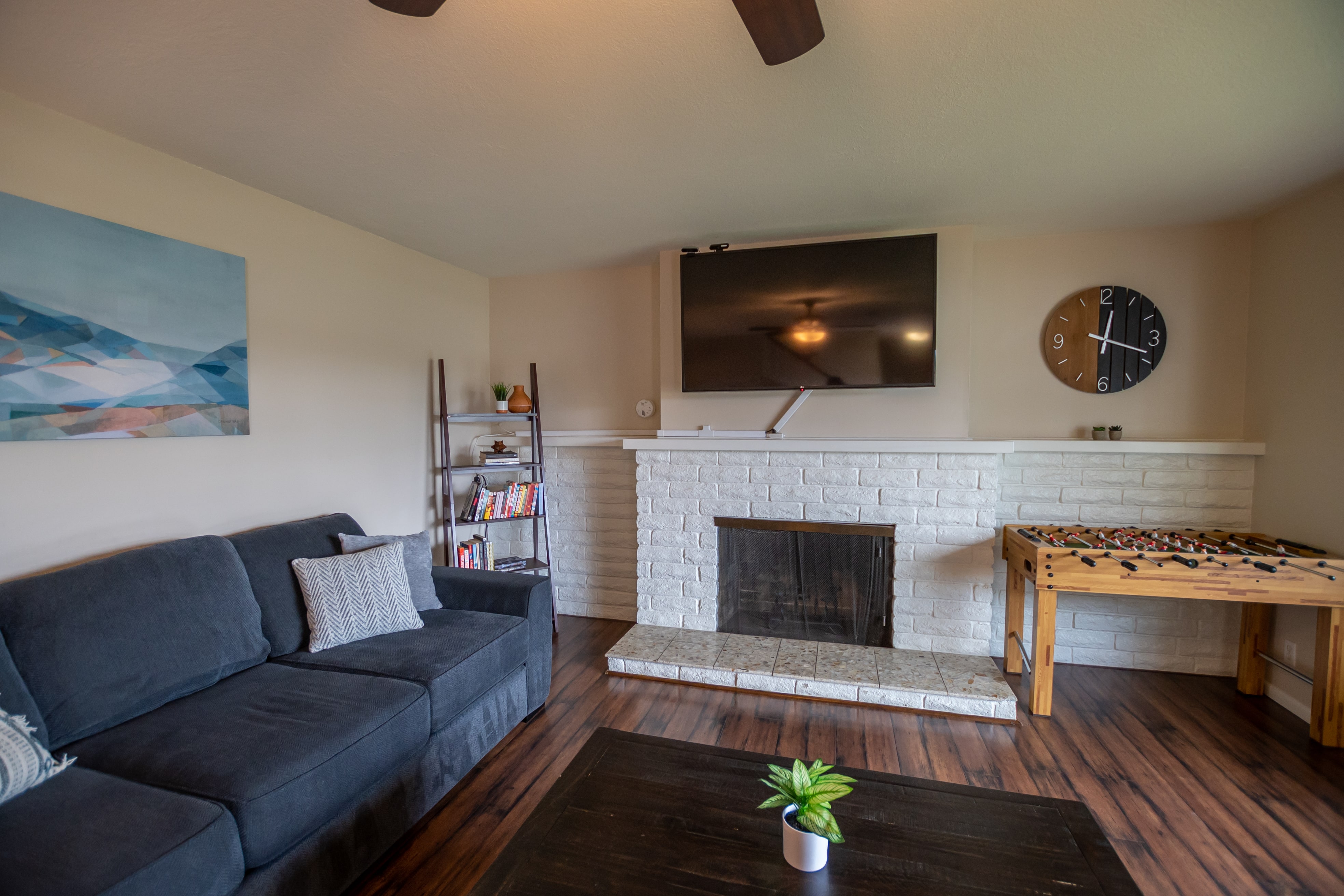 Couch and coffee table near fireplace and TV