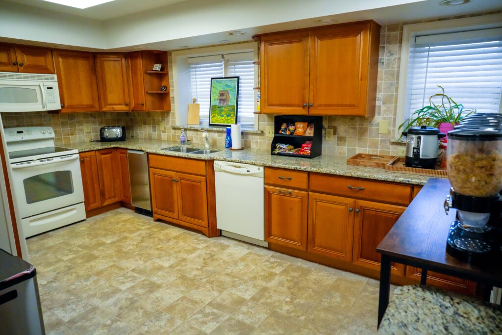 Home-style kitchen with wood cabinets and appliances
