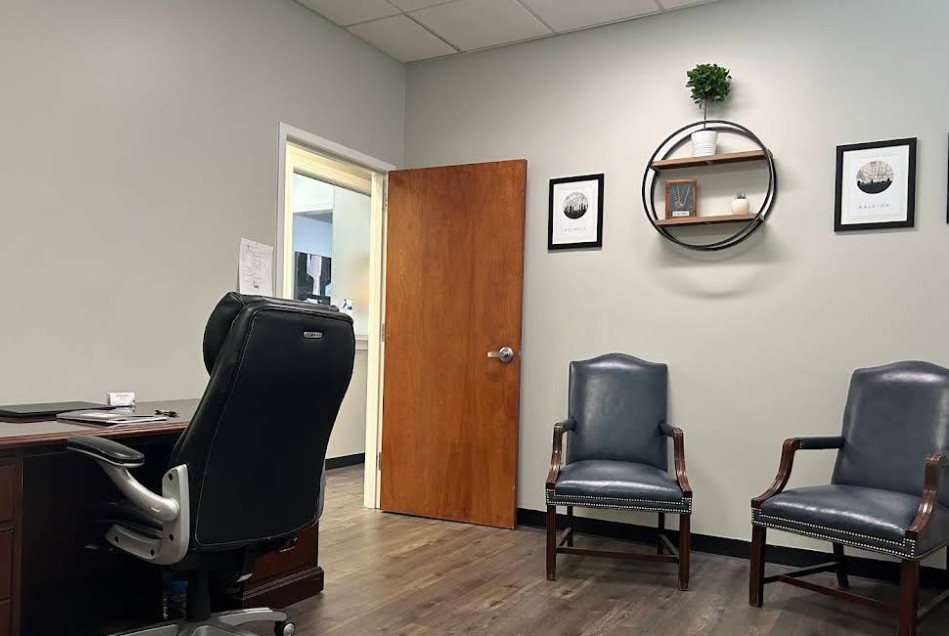 Private counseling office with desk and gue