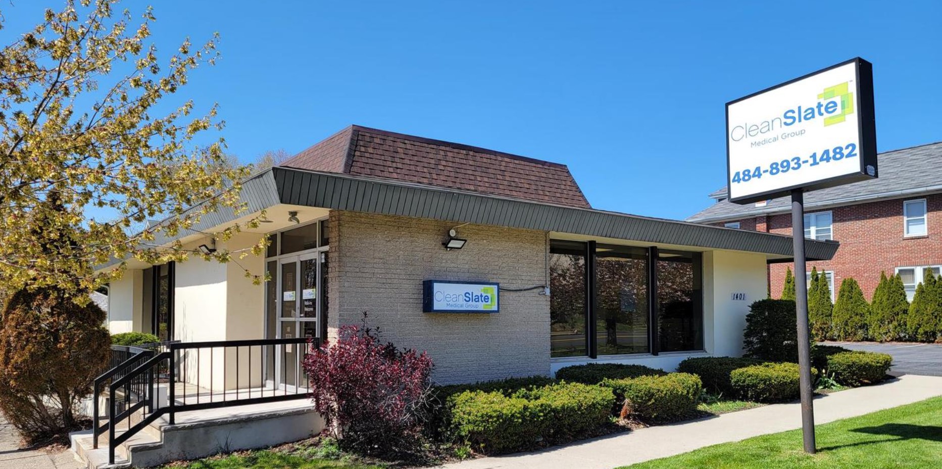 The front entrance of CleanSlate Medical Group, with clear signage and a welcoming pathway for patients and visitors.