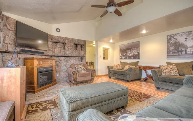 Cozy living area with fireplace, couches, and TV