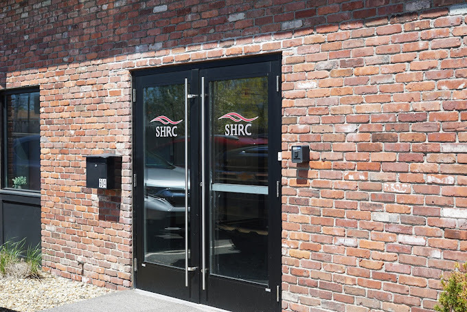 Red-brick exterior with entrance walkway.