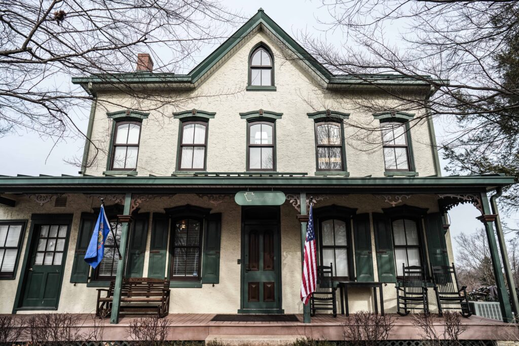Historic house with porch and flags out front