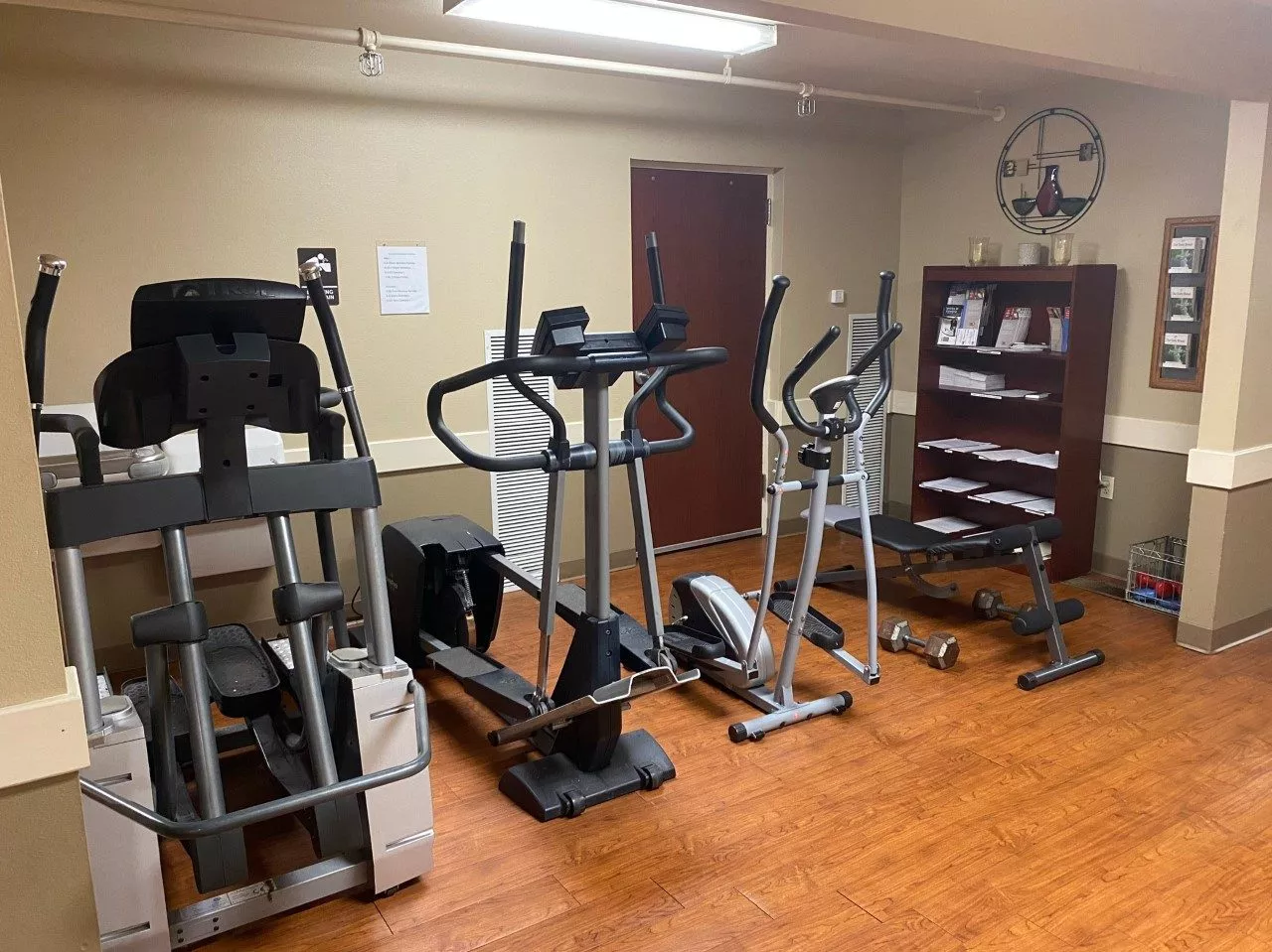 Small gym with cardio machines and light workout equipment