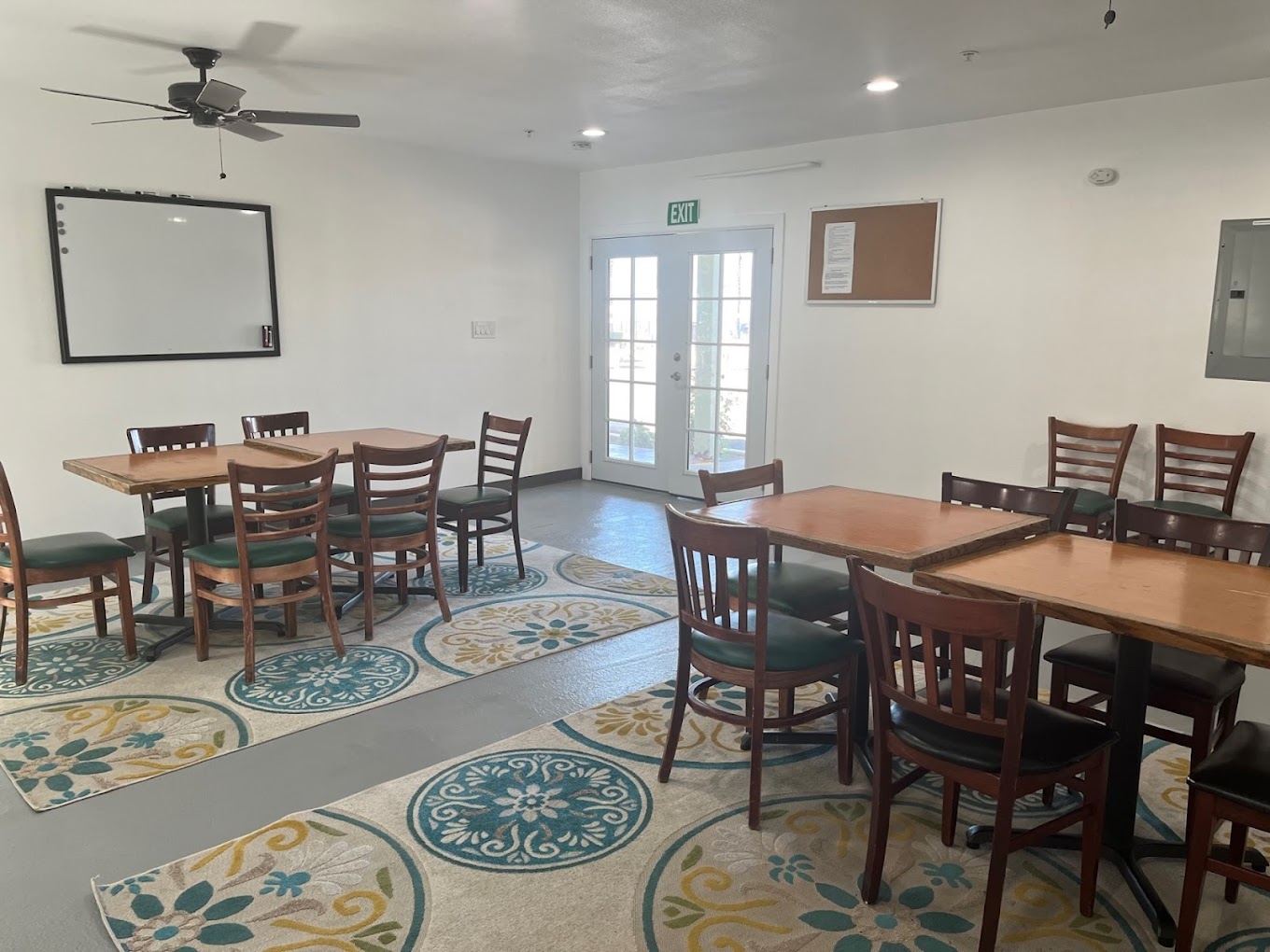 Tables and chairs in group meeting room with wall board