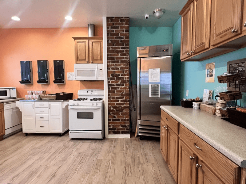 Kitchen with stove, fridge, microwave, and wood cabinets