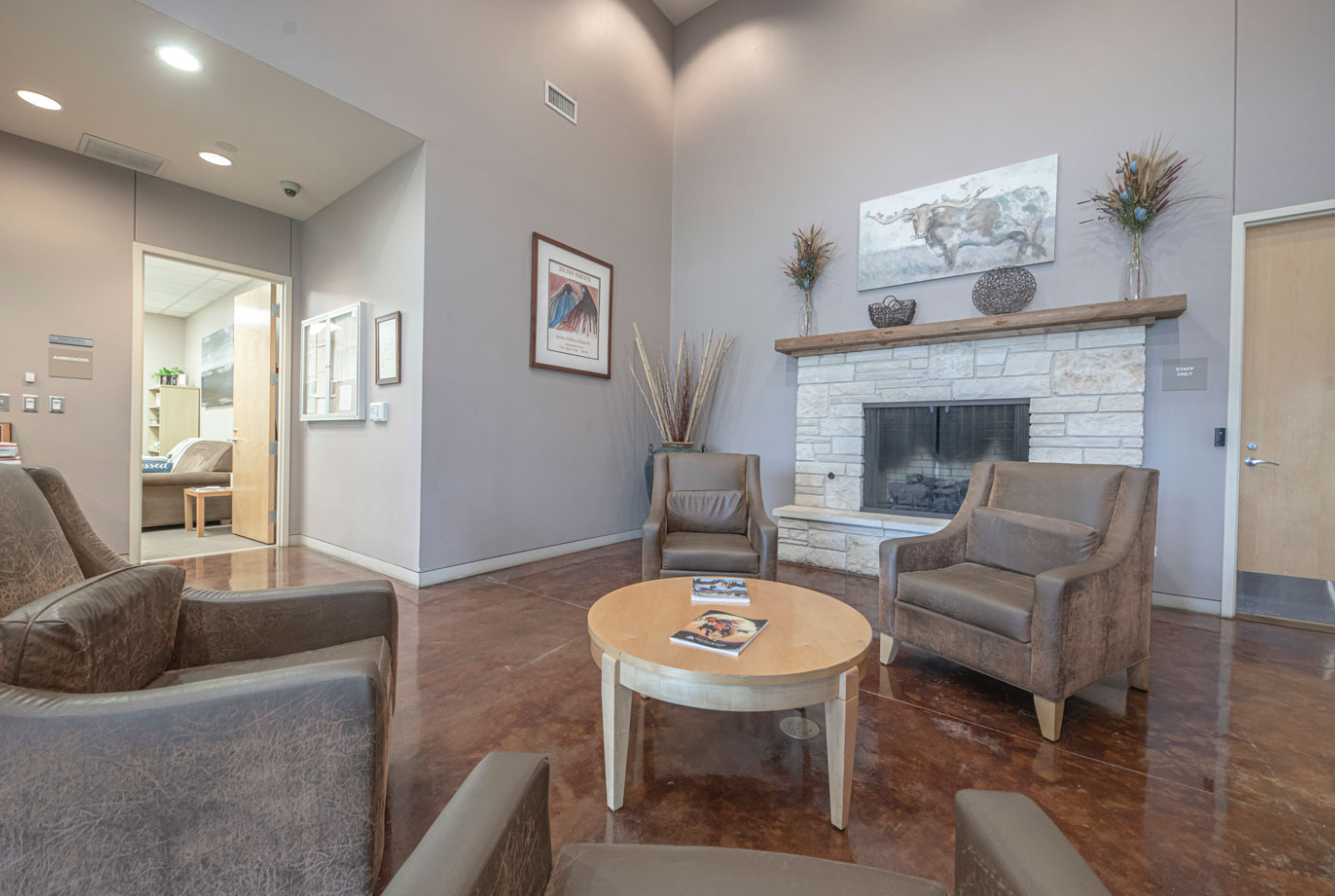 Comfortable admission lobby with seating and fireplace