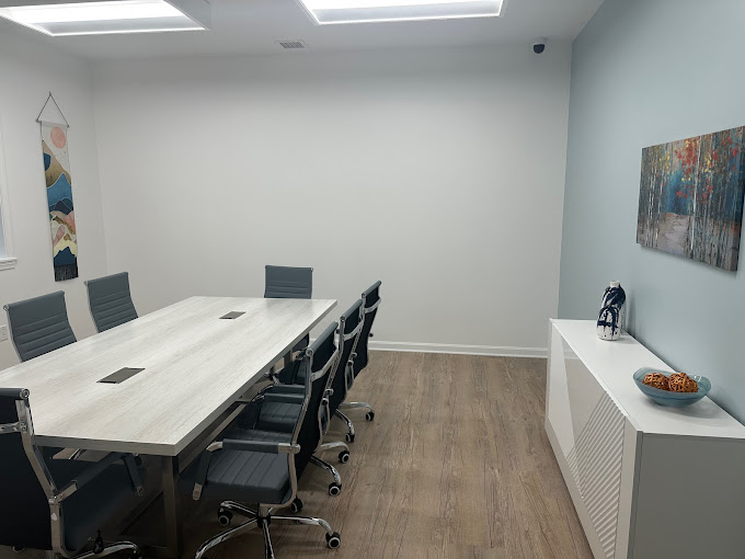 Conference room with meeting table and office chairs