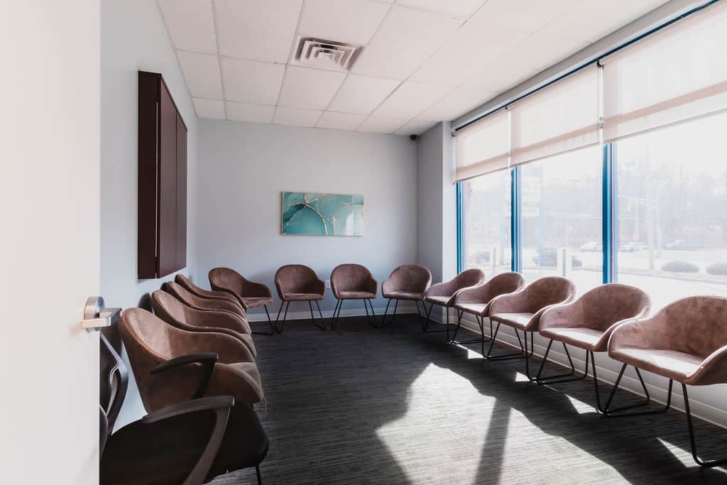 Counseling room with chairs arranged in a circle by large windows