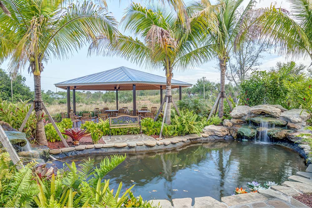Garden pond with waterfall and pavilion seating