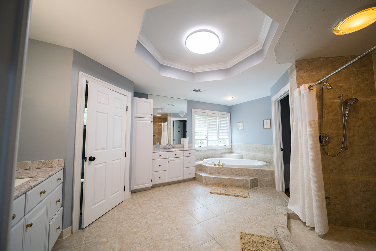 Large bathroom with tub, shower, and vanity