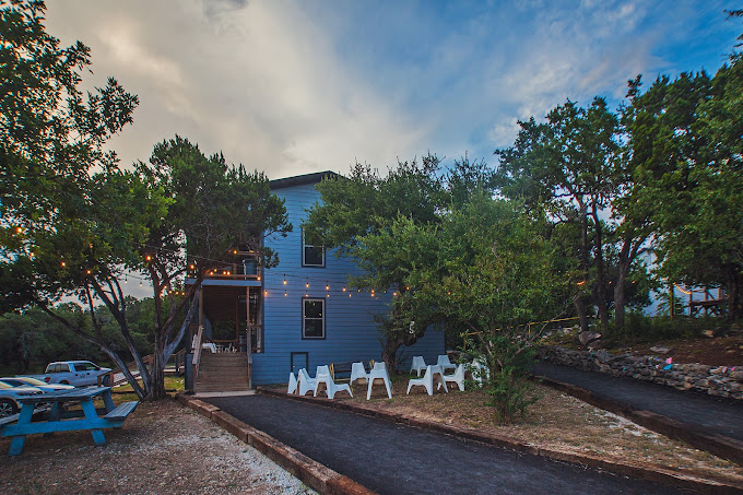 Chairs and string lights near trees and path