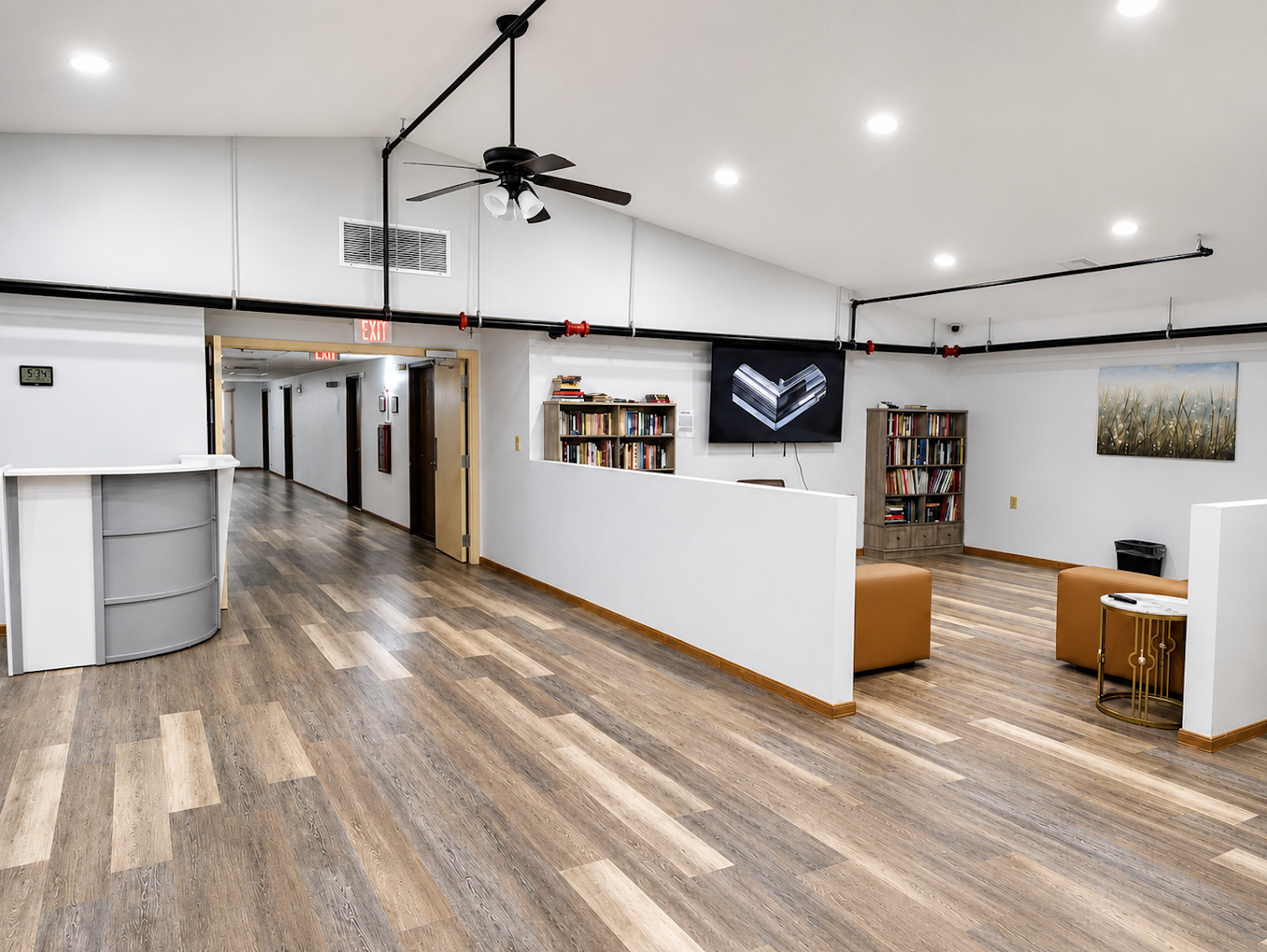 Bright reception area with front desk and wood flooring
