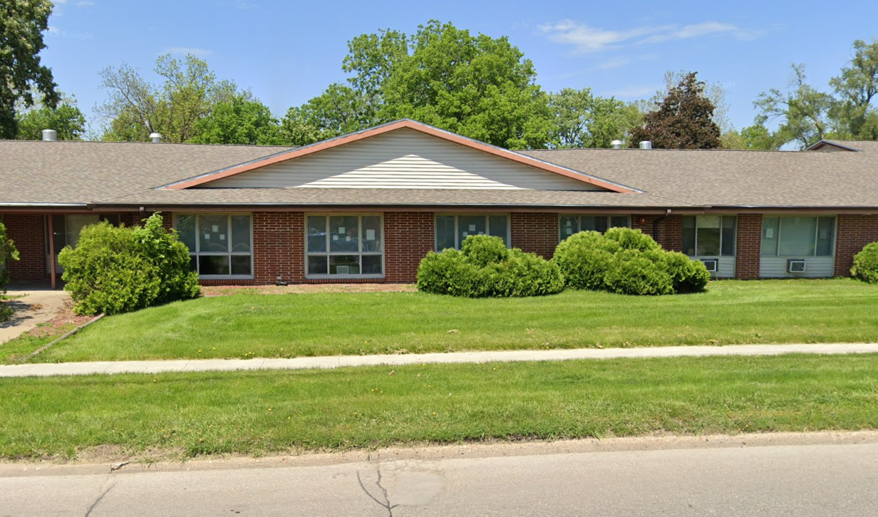Brick rehab facility building with lawn frontage