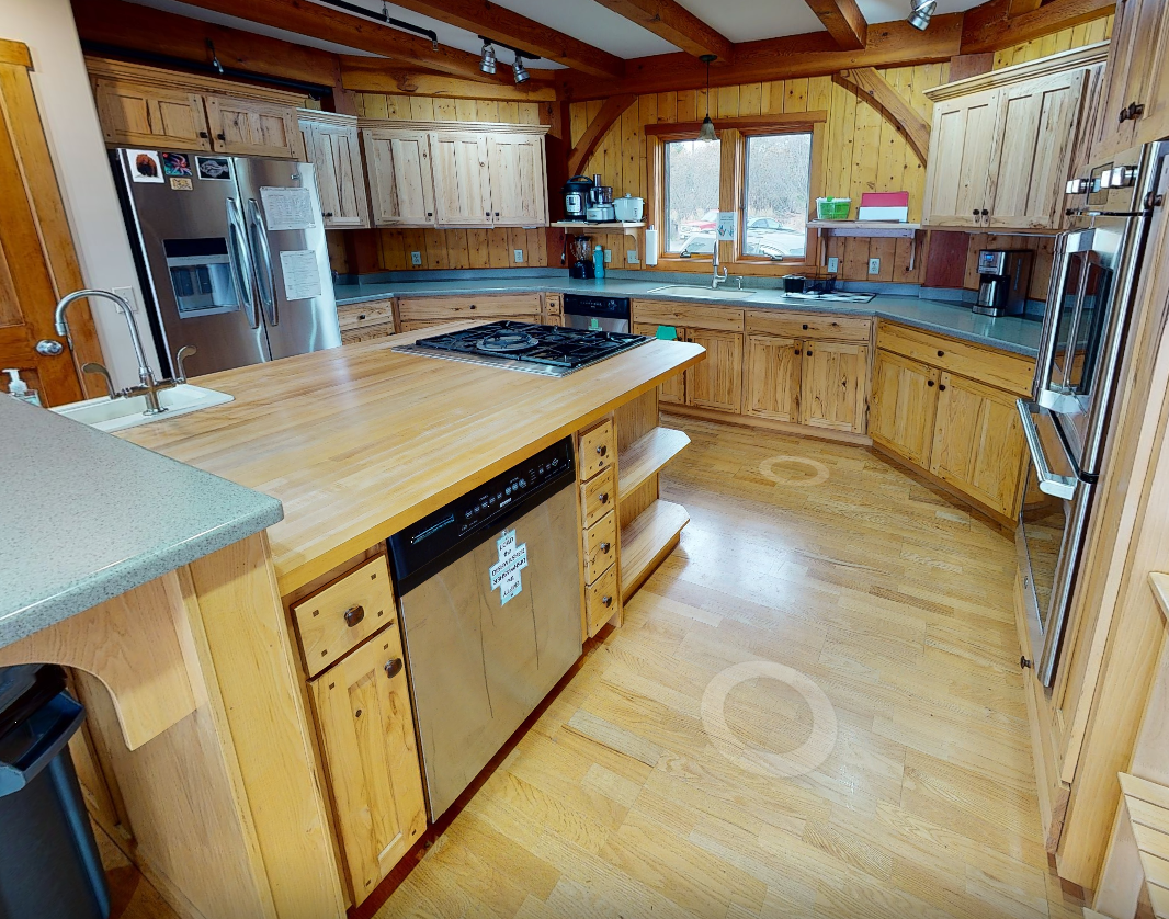 Full kitchen with island, appliances, and wooden cabinetry