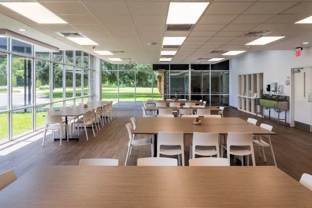 Bright dining space with large windows and wood tables