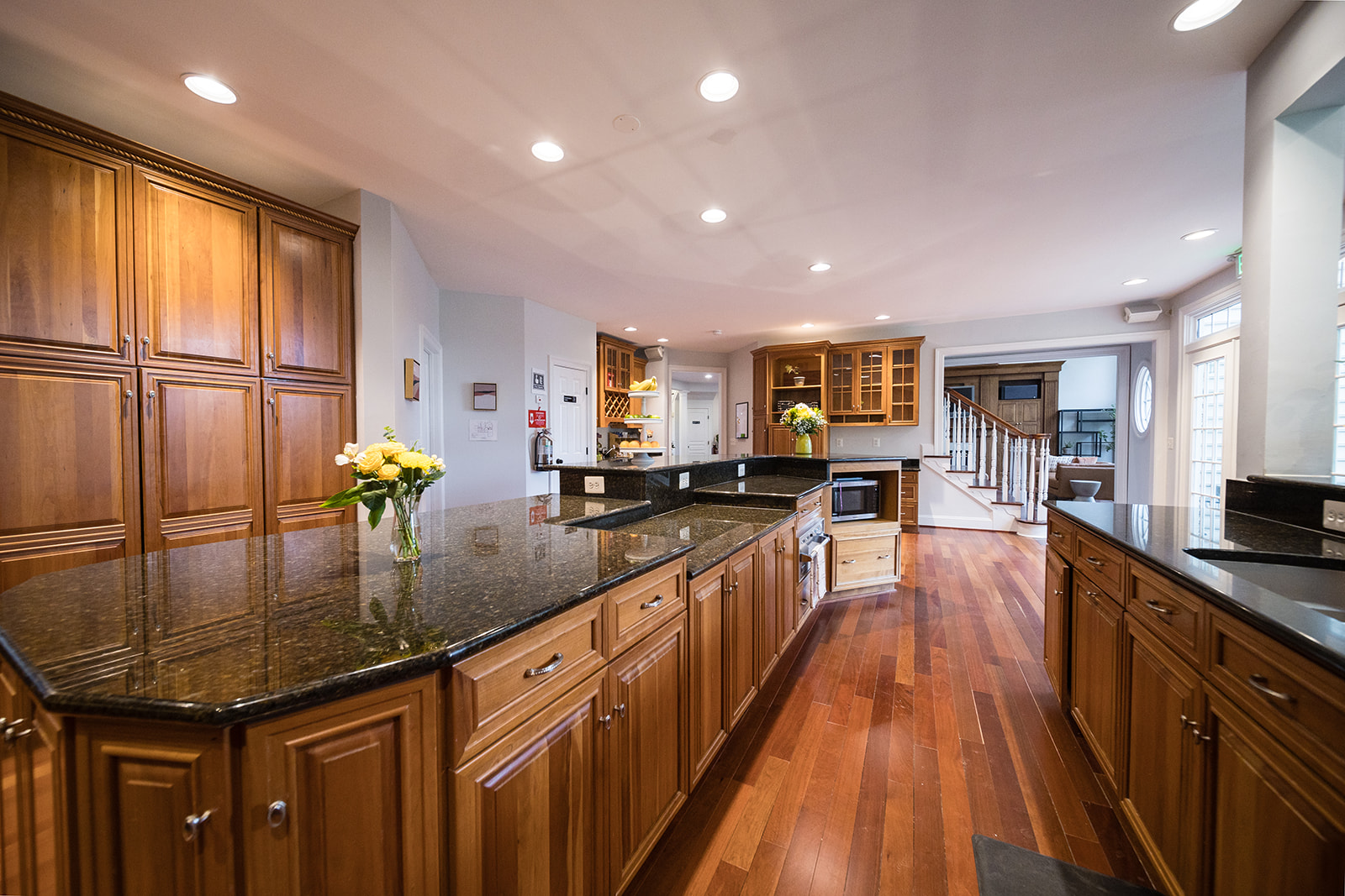 Open kitchen with wood cabinets and granite counters