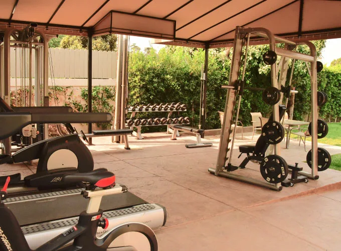 Outdoor gym equipment with patio chairs