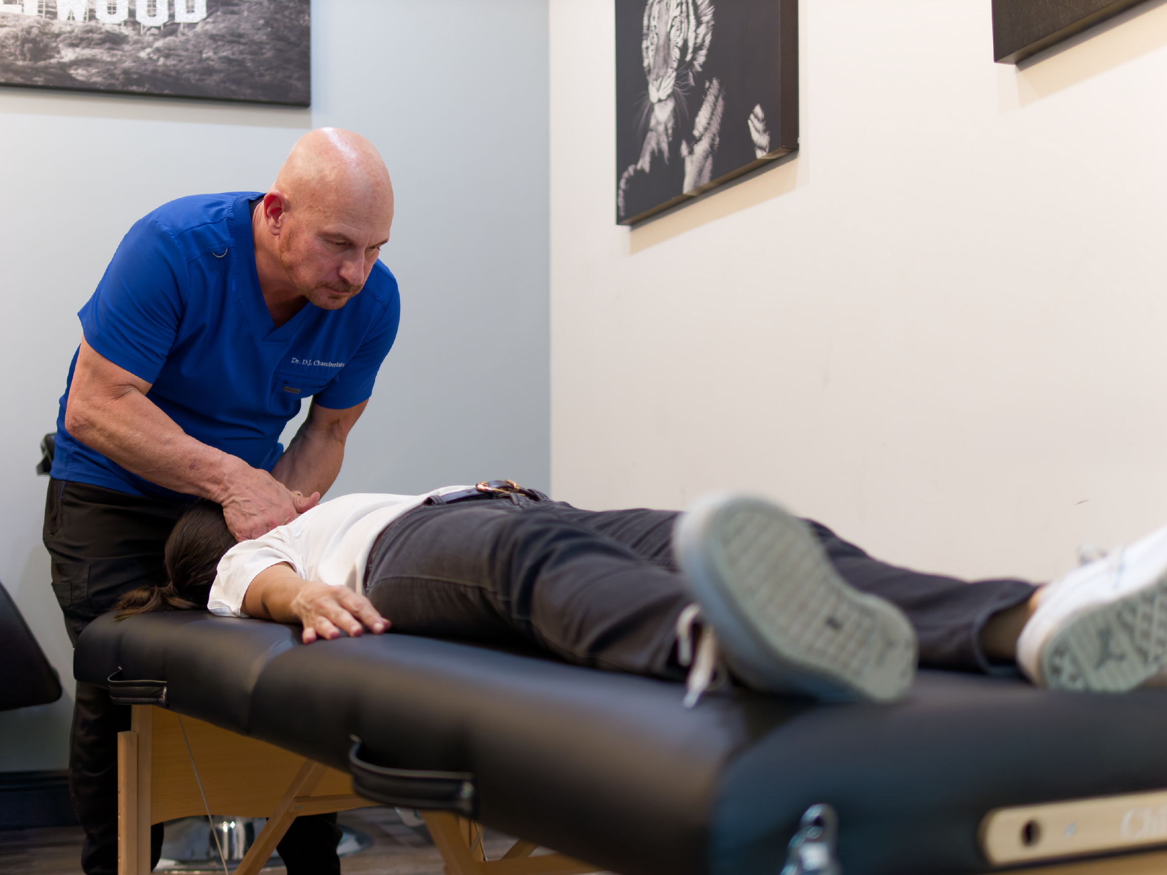 Clinician performing chiropractic adjustment on client