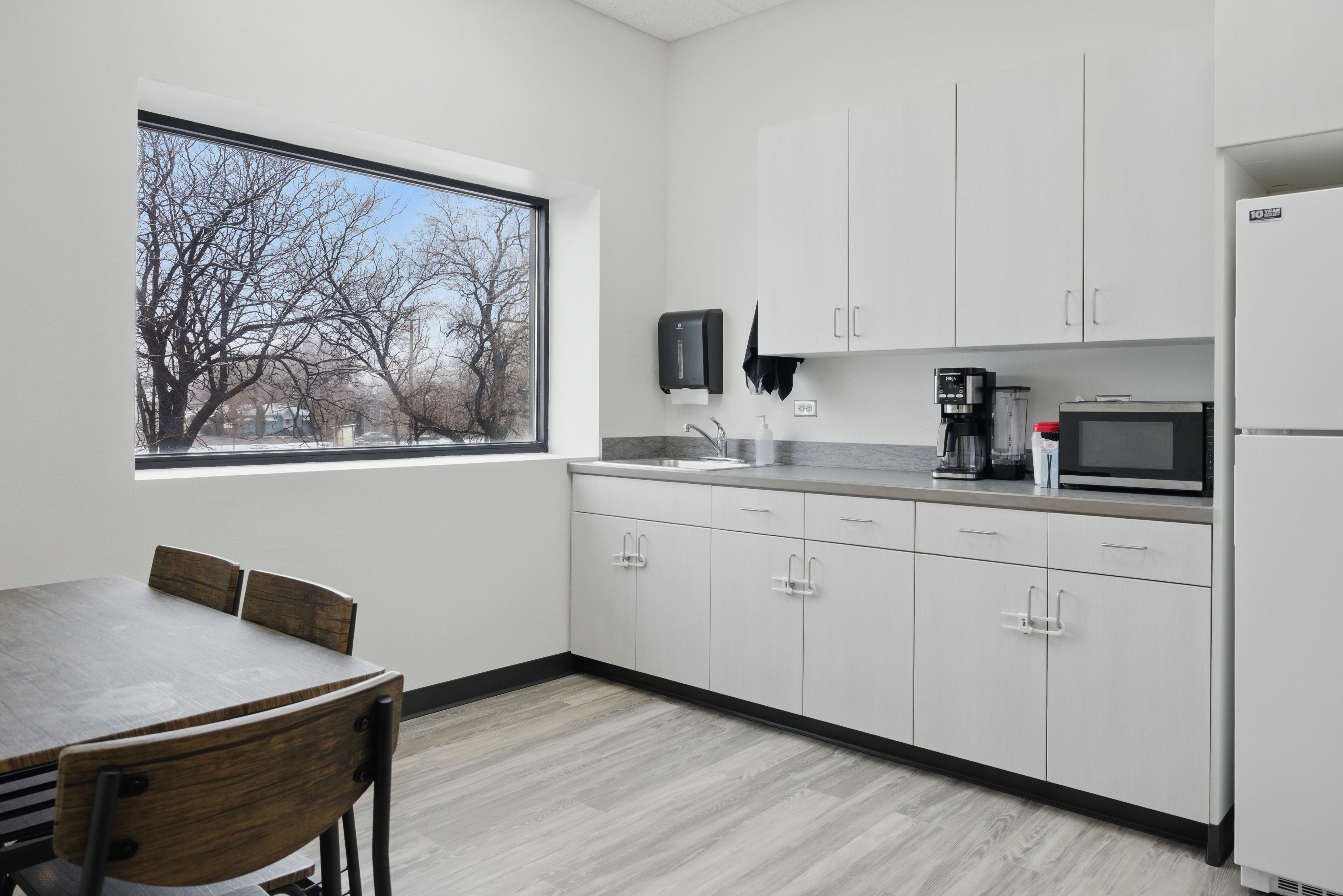 Kitchenette with table, coffee maker, and microwave