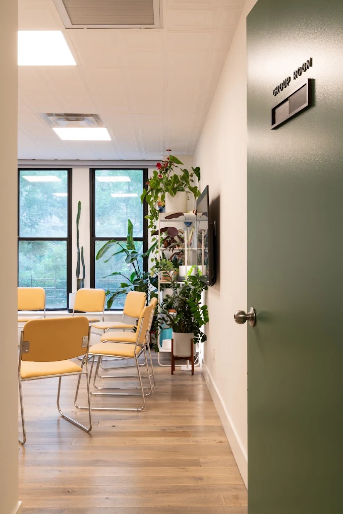Group room with chairs arranged in a circle near windows
