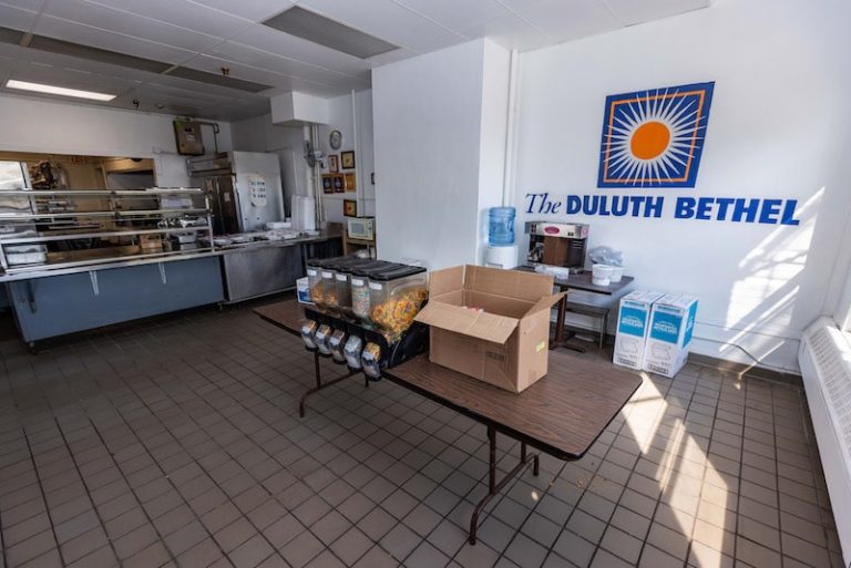 Cafeteria with food counter and Duluth Bethel logo