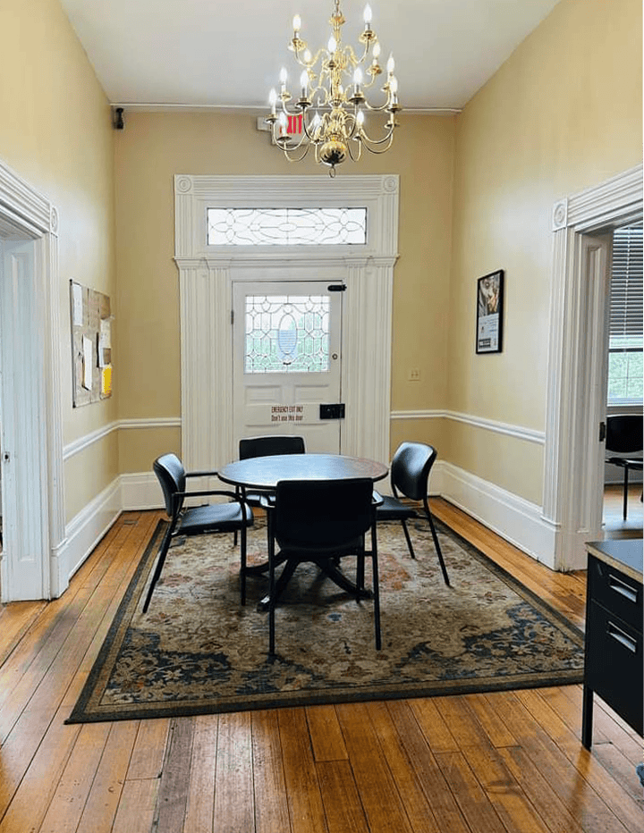 Entry area with chandelier and round table with chairs
