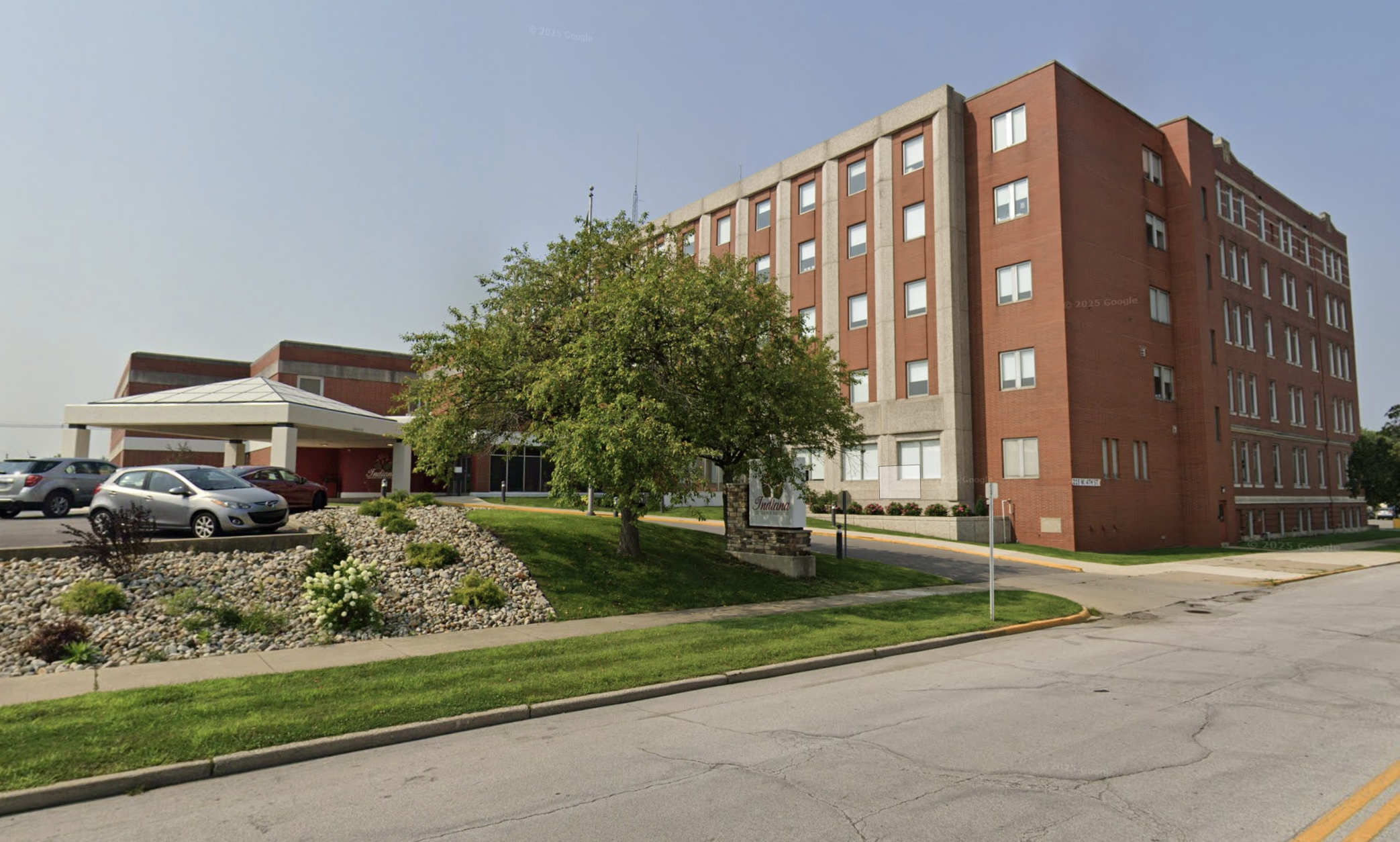 Brick treatment center building with covered entrance and lawn
