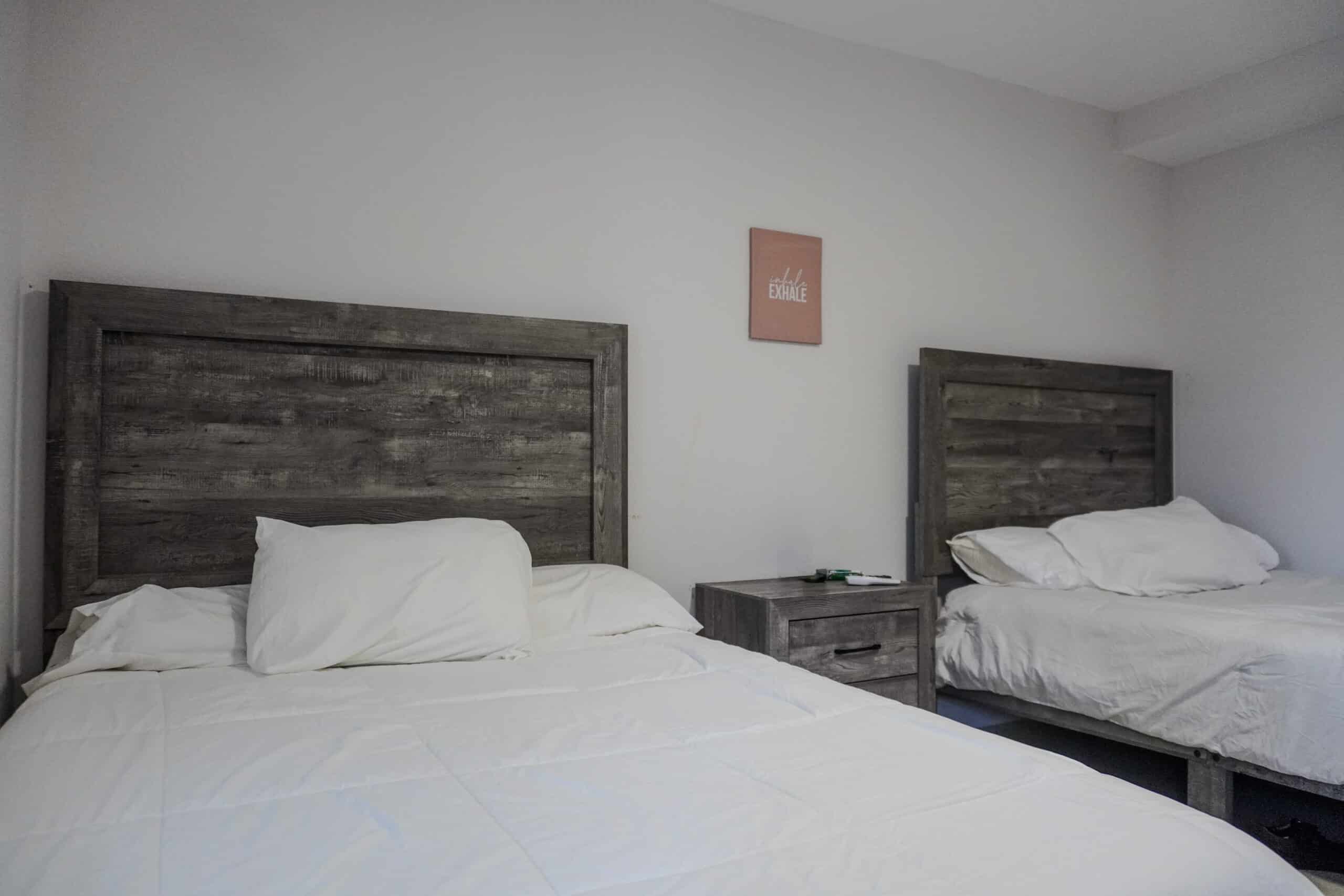 Shared room with two beds and rustic wood furnishings