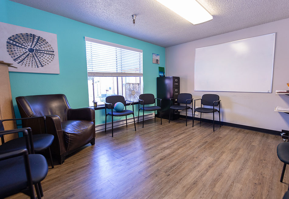 Circle of chairs and whiteboard in a group meeting room