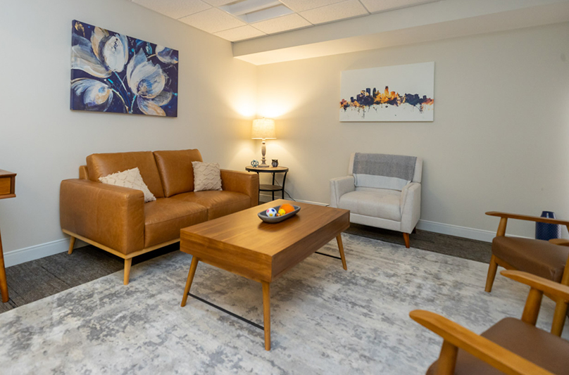 Cozy waiting lounge with sofa, chair, and soft lighting