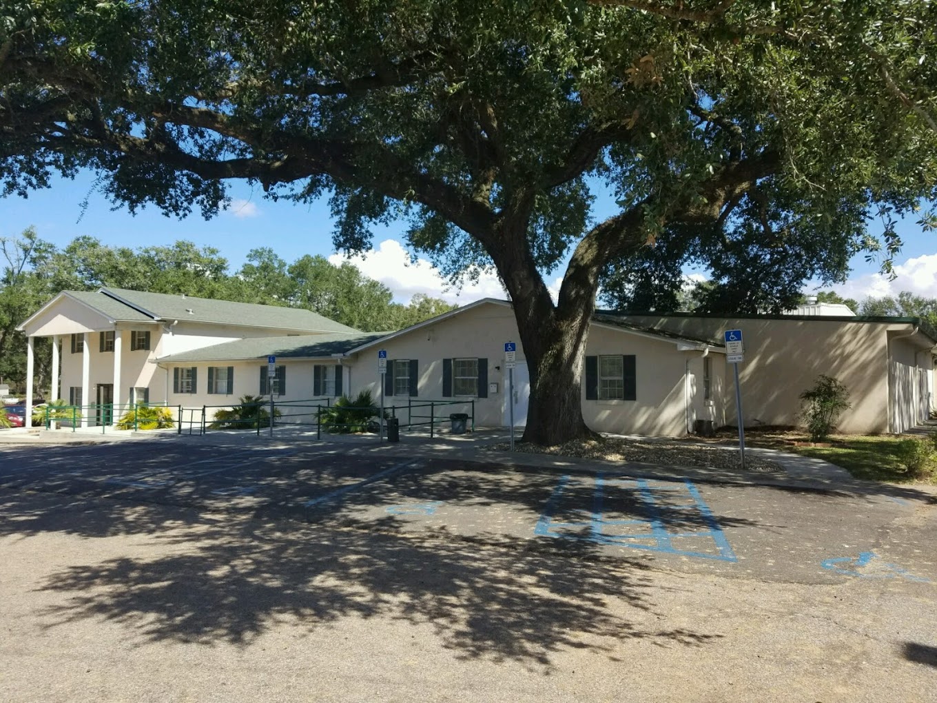 Facility exterior with entrance and accessible parking.