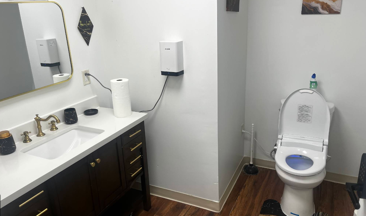 Clean bathroom with sink, mirror, and toilet