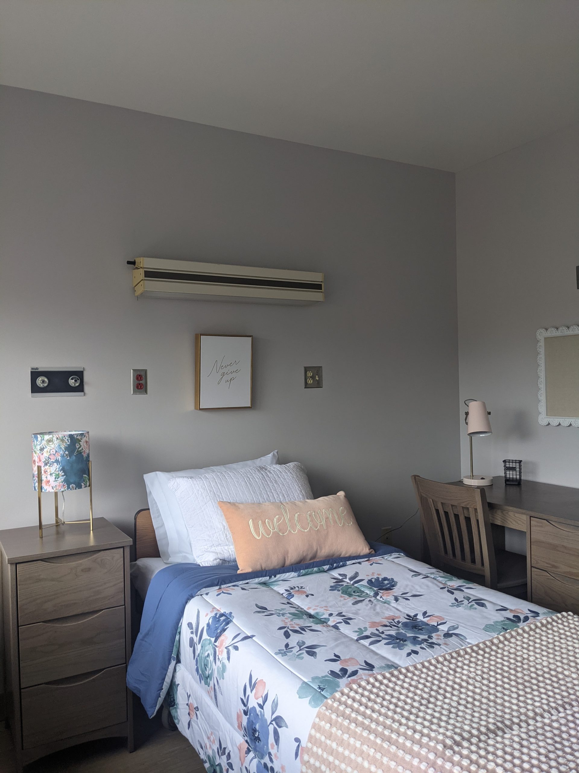 Cozy bedroom with floral bedding and welcome pillow