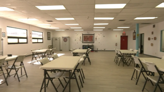 Spacious group therapy room with tables and chairs
