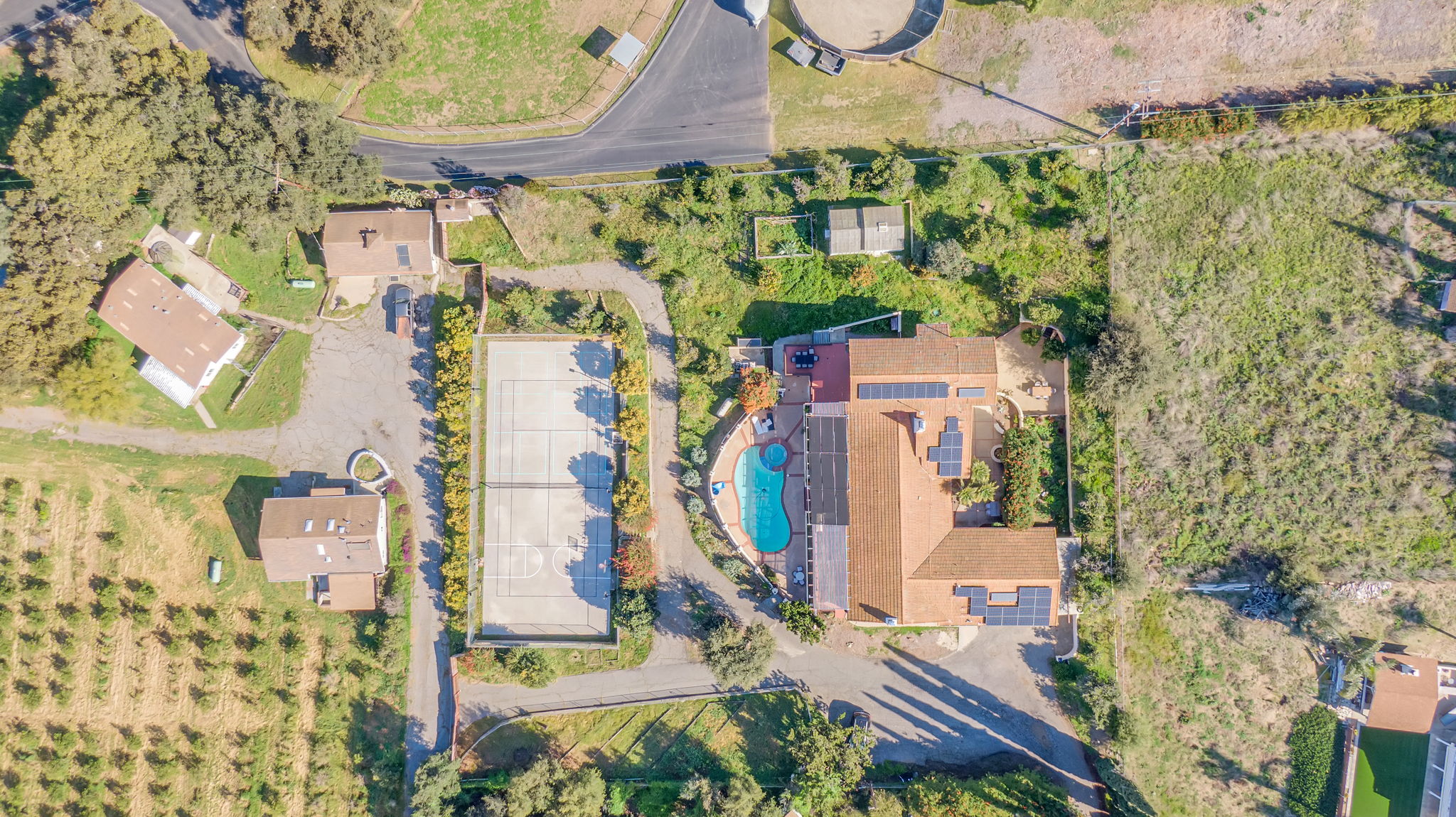 Overhead view of property with pool and sports court