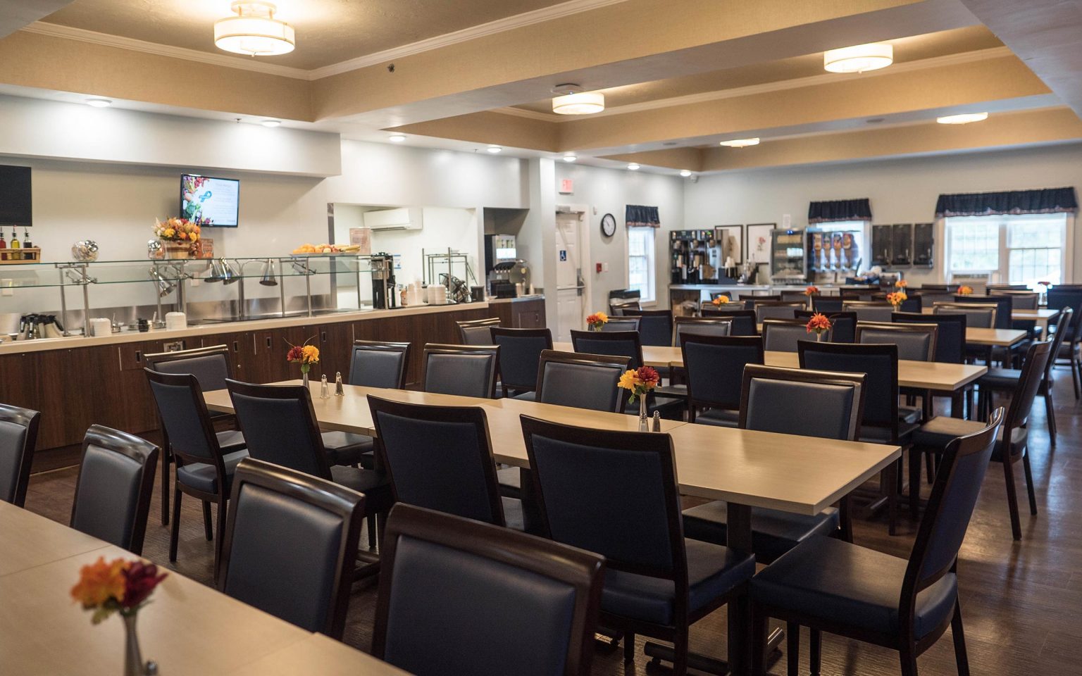 Dining area with tables and chairs, a buffet-sever setup.