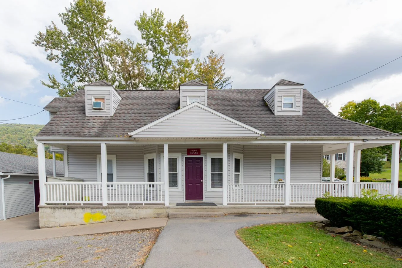White residential rehab house with front porch entrance