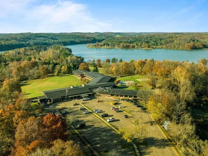 Aerial view of campus grounds surrounded by woods and lake