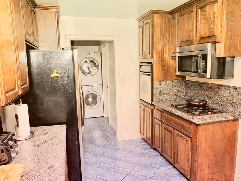 Kitchen with wooden cabinets and stainless steel appliances.