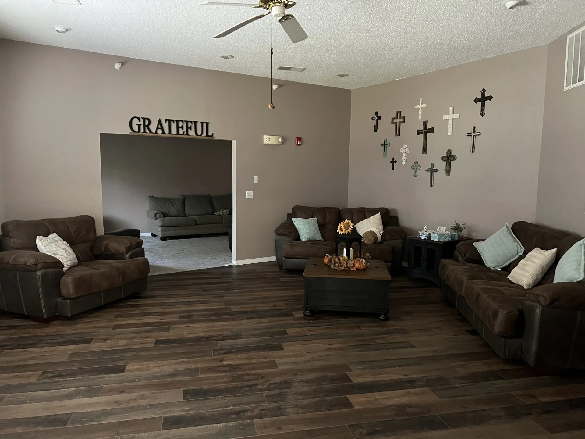 Comfortable lounge with couches and faith-based decor at treatment center