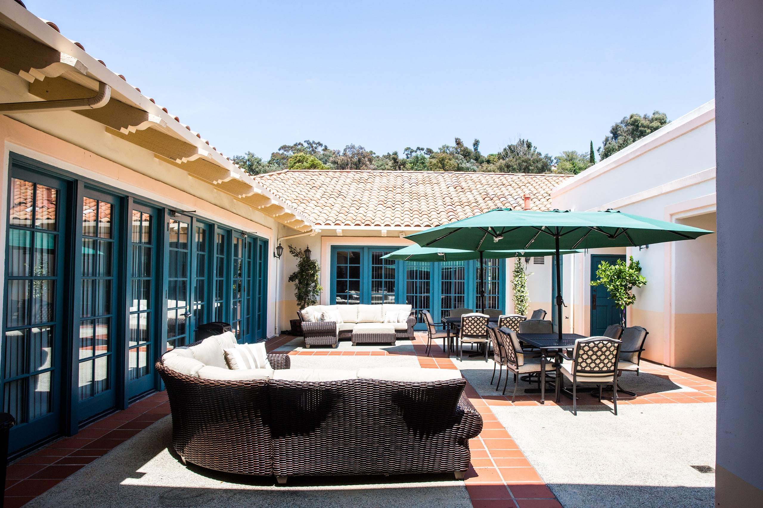 Courtyard with patio seating and green umbrellas